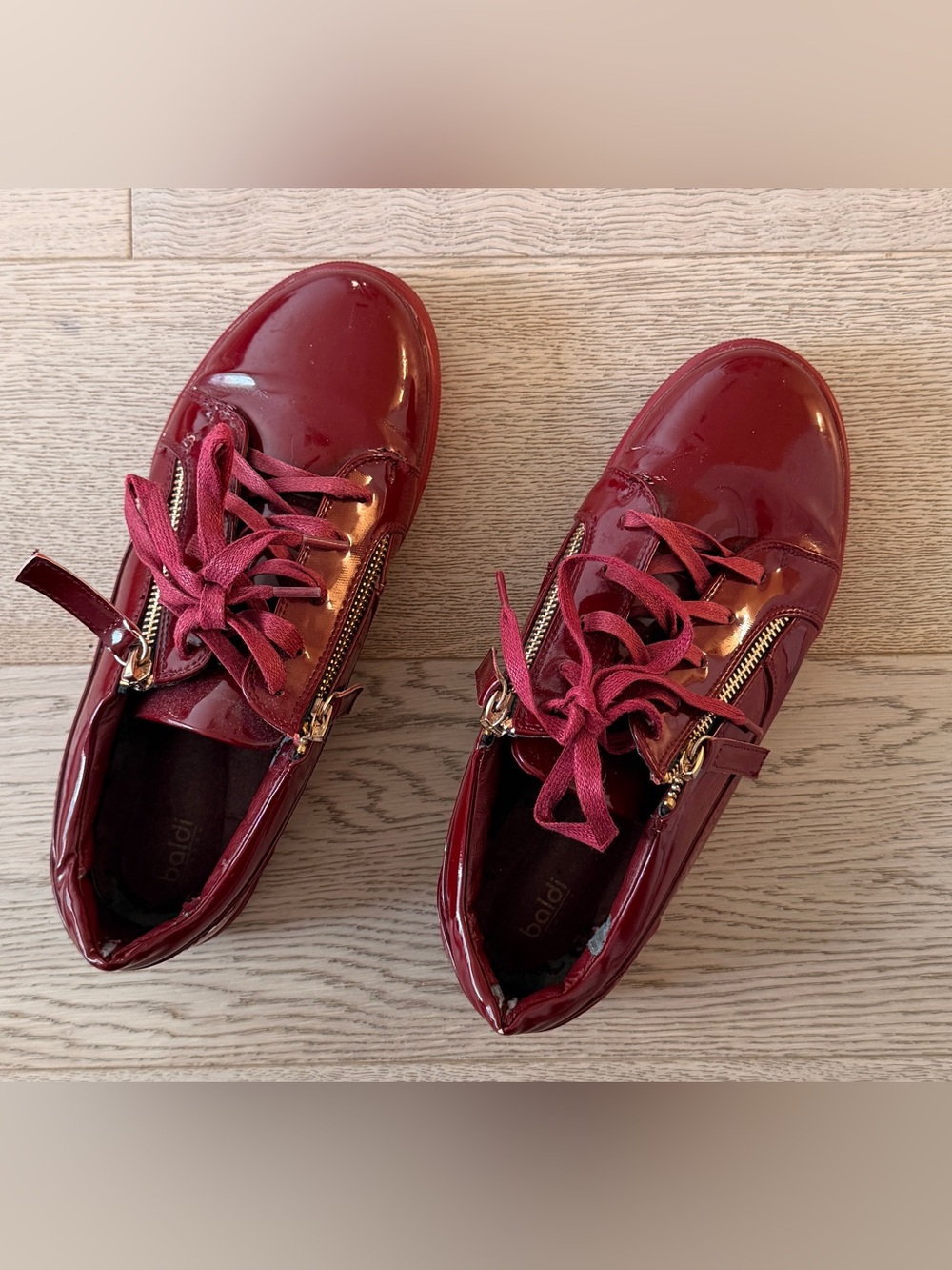 Glossy Burgundy Women's Lace-Up Sneakers with Gold Zipper Detail